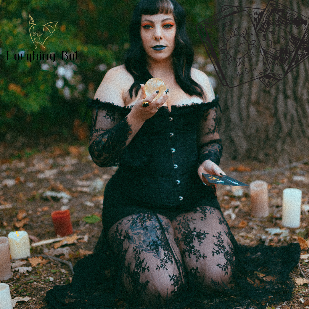 Girl reading tarot in the woods with candles