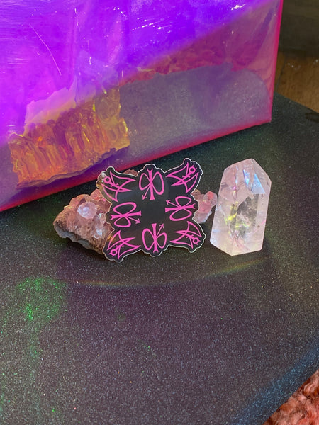 Sticker spread out on a table with crystals