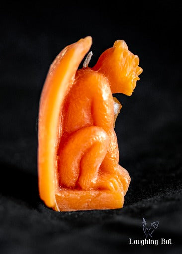 Side view of A Shimmering orange Beeswax Gargoyle with Citrine Crystal Chips